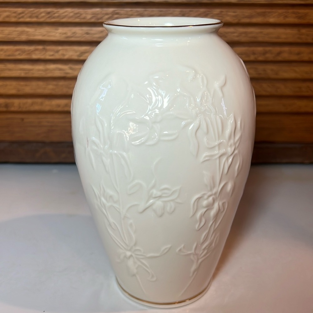 Lenox vase with raised floral design and gold trim rim and base